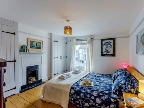 a bedroom with a bed and a fireplace at 3 Bed in Whitstable oc-wcc12 in Whitstable