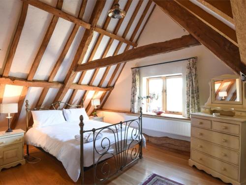 a bedroom with a bed and a dresser and a window at 3 Bed in Briston oc-kt187 in Briston