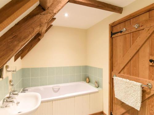a bathroom with a bath tub and a sink at 3 Bed in Briston oc-kt187 in Briston