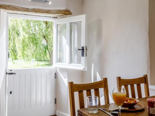 a dining room with a table and a window at 1 Bed in Bedford oc-79095 in Turvey