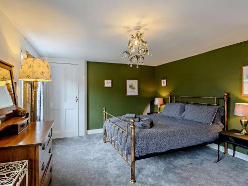 a bedroom with a bed and green walls at 3 Bed in Skegness oc-83461 in Wainfleet All Saints
