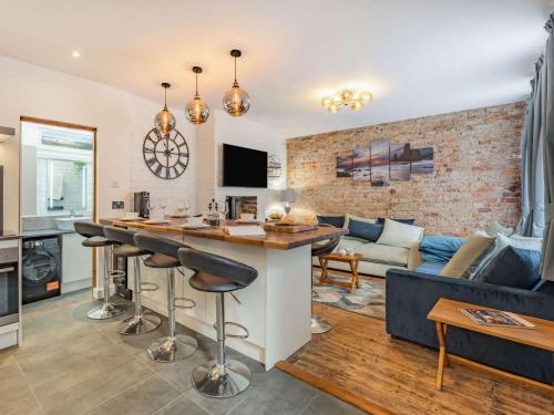 a kitchen and living room with a bar and a couch at 4 Bed in Hastings oc-85916 in Hastings