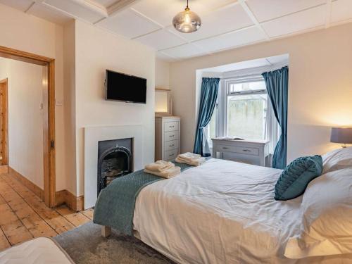 a bedroom with a bed and a fireplace at 4 Bed in Hastings oc-85916 in Hastings