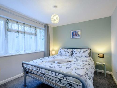 a bedroom with a bed and a window at 3 Bed in Sheringham oc-86262 in Sheringham