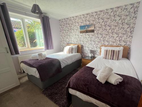 a bedroom with two beds and a window at 2 Bed in Norwich oc-75398 in Mundesley