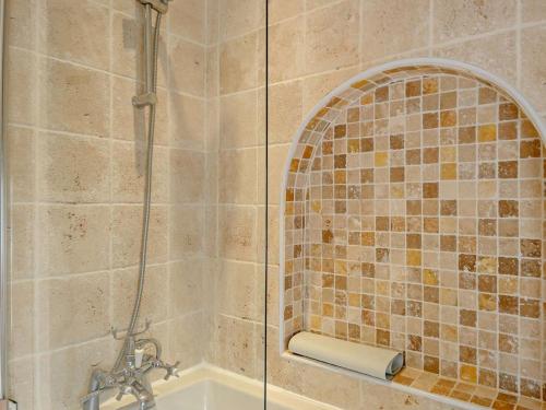 a bathroom with a shower and a tub with a sink at 3 Bed in Norwich oc-47835 in Haddiscoe
