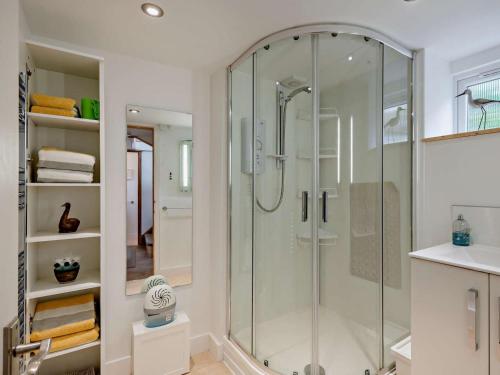 a glass shower in a bathroom with a sink at 1 Bed in North Walsham oc-48723 in Bacton