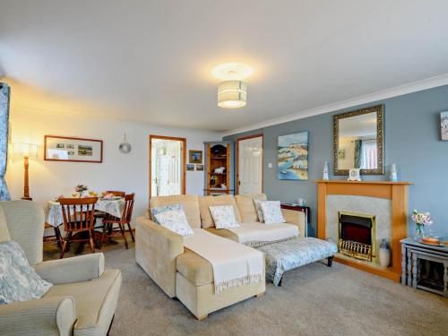 a living room with a couch and a fireplace at 2 Bed in Norwich oc-81322 in Walcott