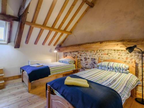 a bedroom with two beds in a attic at 3 Bed in Corpusty oc-ottn8 in Corpusty