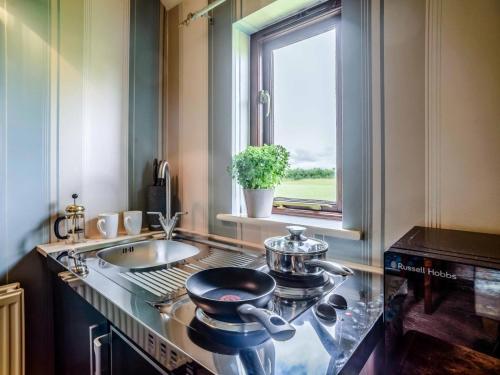 a kitchen with a counter with a sink and a stove at 1 Bed in Bedford oc-78984 in Wyboston