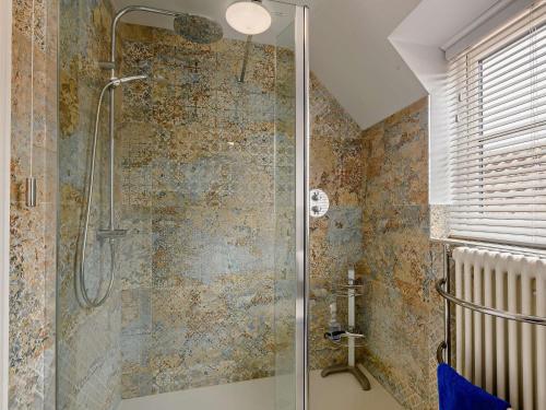a shower with a glass door in a bathroom at 2 Bed in Holt oc-72898 in Holt