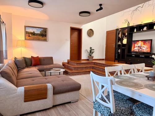 a living room with a couch and a table at Rusínsky Dvor s privátnym Wellness in Malý Lipník