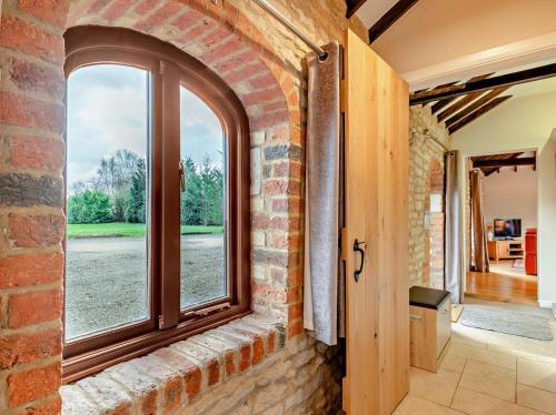 a brick wall with a window in a hallway at 2 Bed in Lincoln oc-91059 in Ashby de la Launde