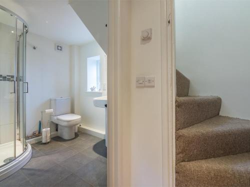 a bathroom with a toilet and stairs with a shower at 2 Bed in Syderstone oc-kt146 in Syderstone