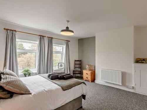 a bedroom with a large bed and a window at 2 Bed in Melton Constable oc-91371 in Briston
