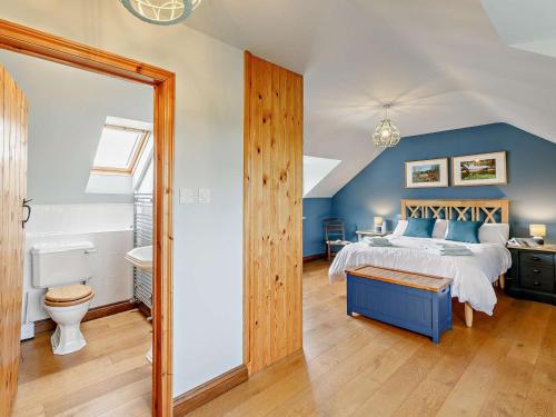 a bedroom with a king sized bed and a bathroom at 3 Bed in Market Rasen oc-93253 in Ranby