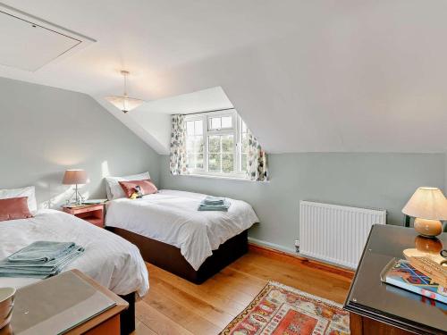 a bedroom with two beds and a window at 3 Bed in Market Rasen oc-93253 in Ranby