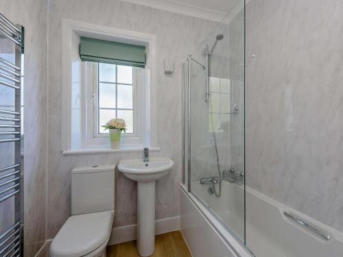 a bathroom with a toilet sink and a shower at 3 Bed in Bognor Regis oc-83115 in Bognor Regis