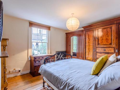 a bedroom with a large bed and a chandelier at 3 Bed in Faversham oc-78880 in Faversham