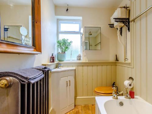 a bathroom with a radiator and a sink and a window at 3 Bed in Faversham oc-78880 in Faversham