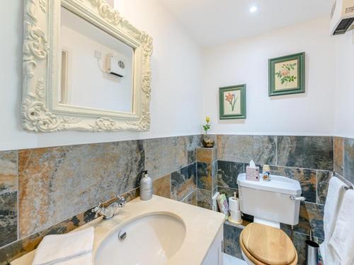 a bathroom with a sink and a mirror on the wall at 1 Bed in Lewes oc-79182 in Beddingham