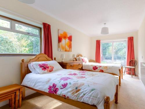 a bedroom with two beds and a window at 2 Bed in Dereham oc-shrn8 in East Dereham