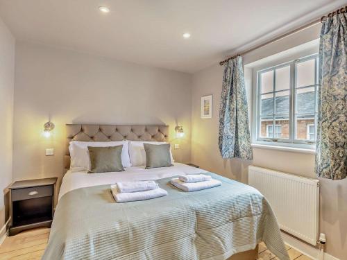a bedroom with a bed with two towels on it at 3 Bed in Colchester oc-94016 in Dedham