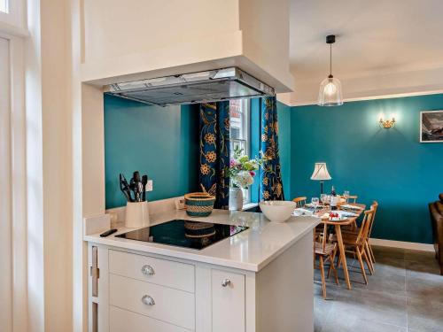 a kitchen with a stove and a dining room at 3 Bed in Colchester oc-94016 in Dedham
