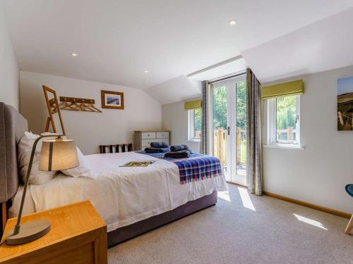 a bedroom with a bed and a large window at 2 Bed in Uckfield oc-80504 in Framfield