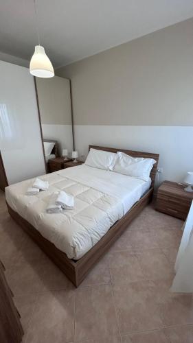 a bedroom with a large bed with white sheets at Casa Memi in Chioggia