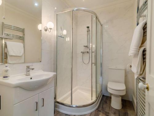 a bathroom with a shower and a sink and a toilet at 5 Bed in Wisbech oc-90134 in Wisbech