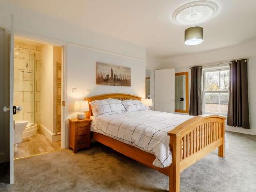 a bedroom with a large bed and a bathroom at 5 Bed in Wisbech oc-90134 in Wisbech