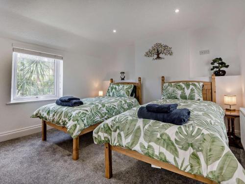 a bedroom with two beds and a window at 3 Bed in Bognor Regis oc-93447 in Bognor Regis
