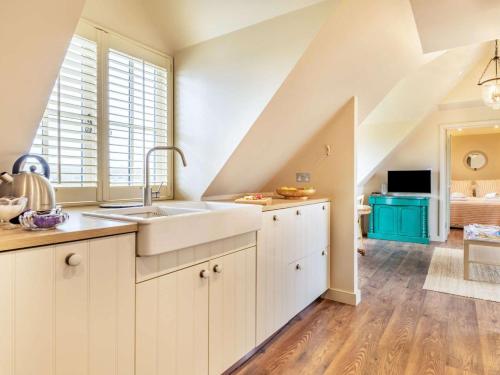 a kitchen with white cabinets and a sink at 1 Bed in Horsham oc-86961 in Rudgwick