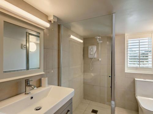 a bathroom with a sink and a glass shower at 1 Bed in Kings Lynn oc-32202 in Beeston