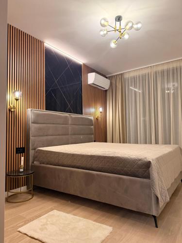a bedroom with a bed and a ceiling fan at NOIR Luxury in Trebinje