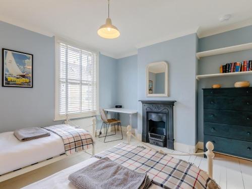 a bedroom with a bed and a fireplace at 3 Bed in Whitstable oc-84042 in Whitstable