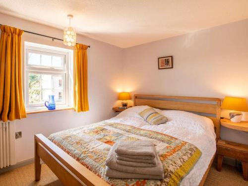 a bedroom with a bed with towels on it at 2 Bed in Lowestoft oc-88109 in Lowestoft
