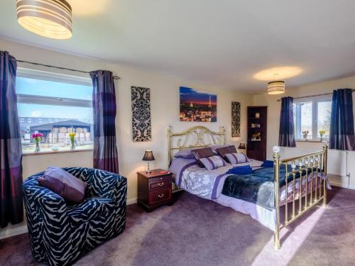a bedroom with a bed and a chair at 3 Bed in Dereham oc-65903 in Foulsham