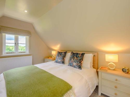 a bedroom with a large bed and a window at 1 Bed in Battle oc-88029 in Brightling