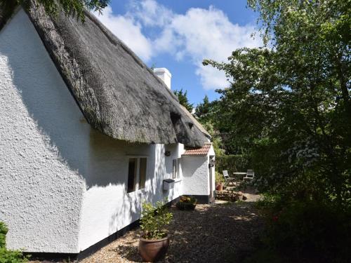 a white cottage with a thatched roof at 2 Bed in Bedford oc-62322 in Wyboston