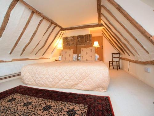 a bedroom with a large bed in a attic at 2 Bed in Bedford oc-62322 in Wyboston
