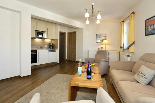 a living room with a couch and a table at Turmwohnung 205 in Juist