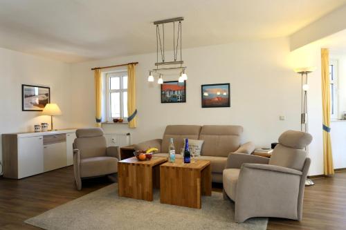 a living room with a couch and a table at Turmwohnung 205 in Juist