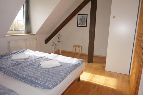 a bedroom with a bed with two towels on it at Doppelzimmer mit Bad in Möllenhagen