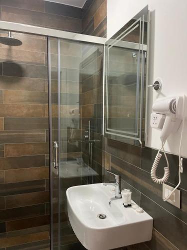 a bathroom with a sink and a shower at Hotel Adria 2 Shengjin in Shëngjin