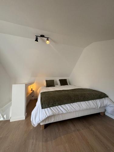 a bedroom with a large bed in a attic at Maison Aline in Hotton
