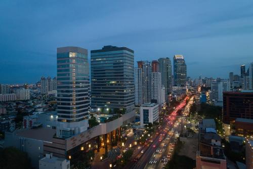 a view of a city at night with traffic at Jubilee Prestige Hotel Ratchadapisek in Bangkok