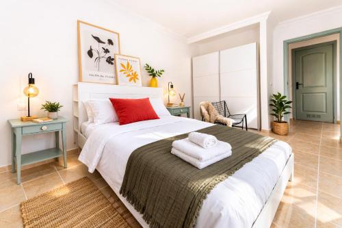 a bedroom with a large bed with red pillows on it at Profithome-Punta Larga in Candelaria