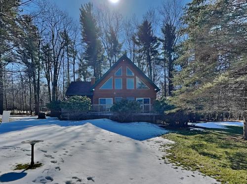 a house with snow in front of it at Almost Heaven in Swanton